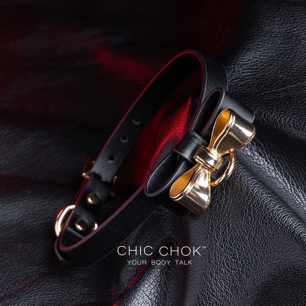 Elegant choker featuring a golden bow design symbolizing nobility, unity, and individuality, set against a vibrant color contrast to represent diverse social statuses, personalities, and backgrounds while celebrating love and mutual respect.