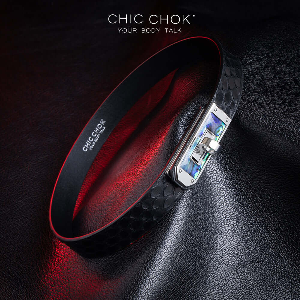 chicchok black python hide collar with green sea shell buckle, featuring a mysterious and mature vibe, luxury textured design for bold fashion statements.