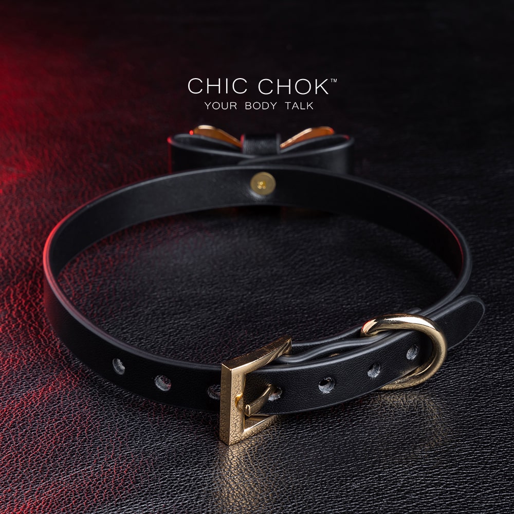 Elegant choker featuring a golden bow design symbolizing nobility, unity, and individuality, set against a vibrant color contrast to represent diverse social statuses, personalities, and backgrounds while celebrating love and mutual respect.